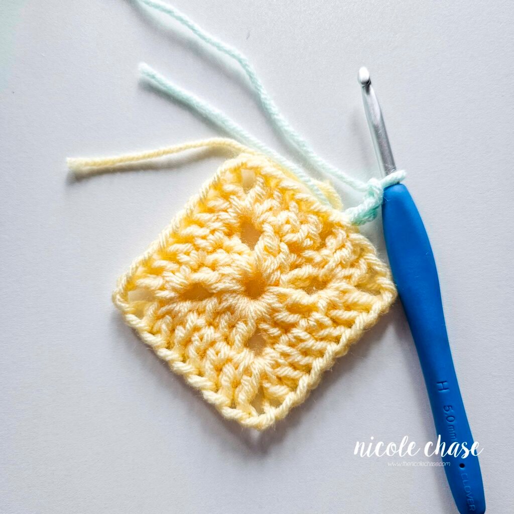 R3 of crocheting the blanket portion of the lion lovey crochet pattern in a mint color, part 1.