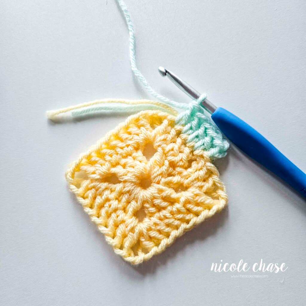 R3 of crocheting the blanket portion of the lion lovey crochet pattern in a mint color, part 2.