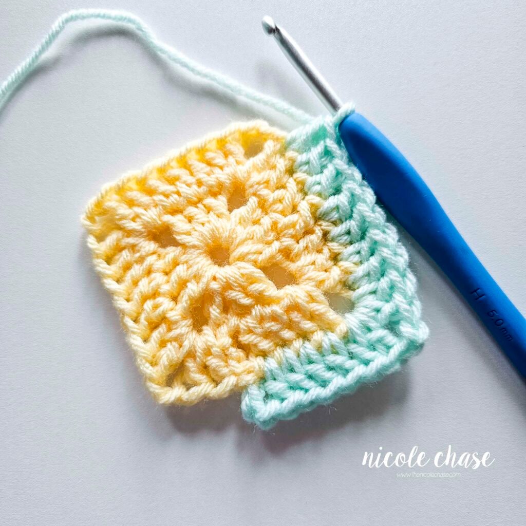 R3 of crocheting the blanket portion of the lion lovey crochet pattern in a mint color, part 4.