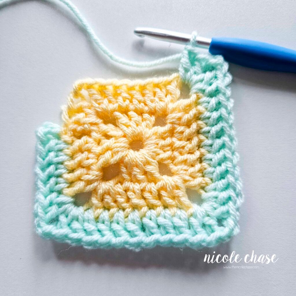 R3 of crocheting the blanket portion of the lion lovey crochet pattern in a mint color, part 7.