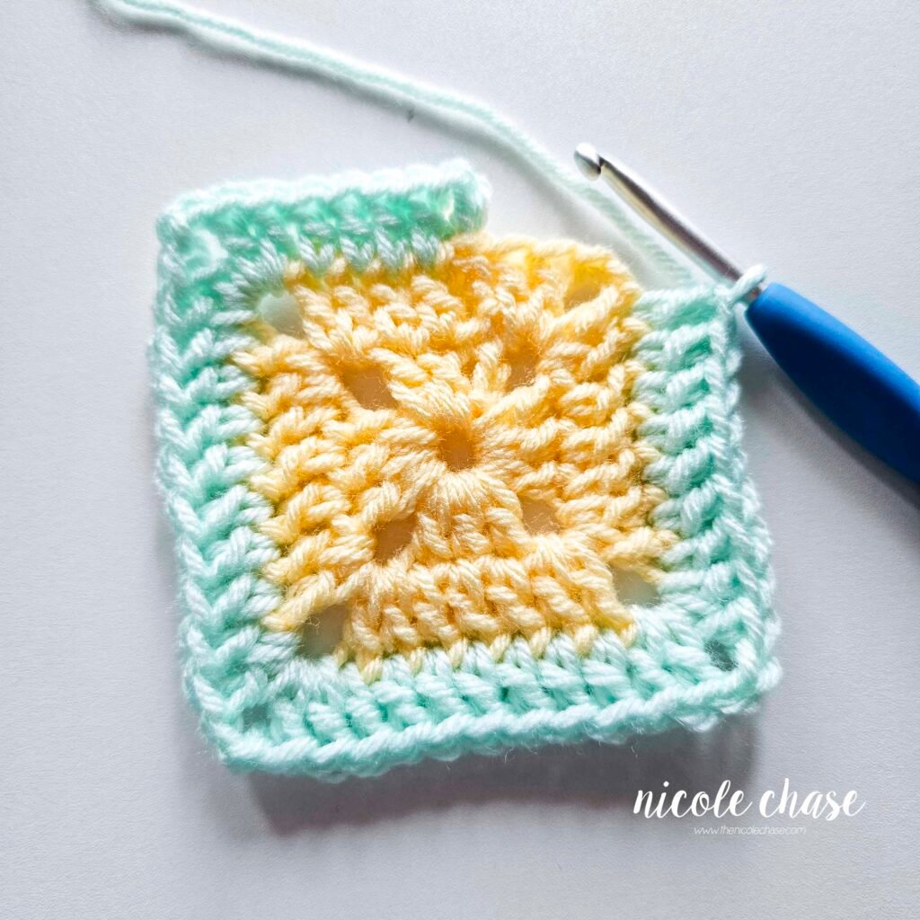 R3 of crocheting the blanket portion of the lion lovey crochet pattern in a mint color, part 8.