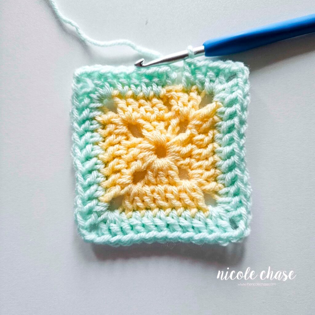 R3 of crocheting the blanket portion of the lion lovey crochet pattern in a mint color, part 10.