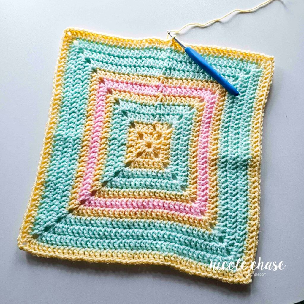 The blanket of the crochet lion lovey pattern before working the single crochet edging.