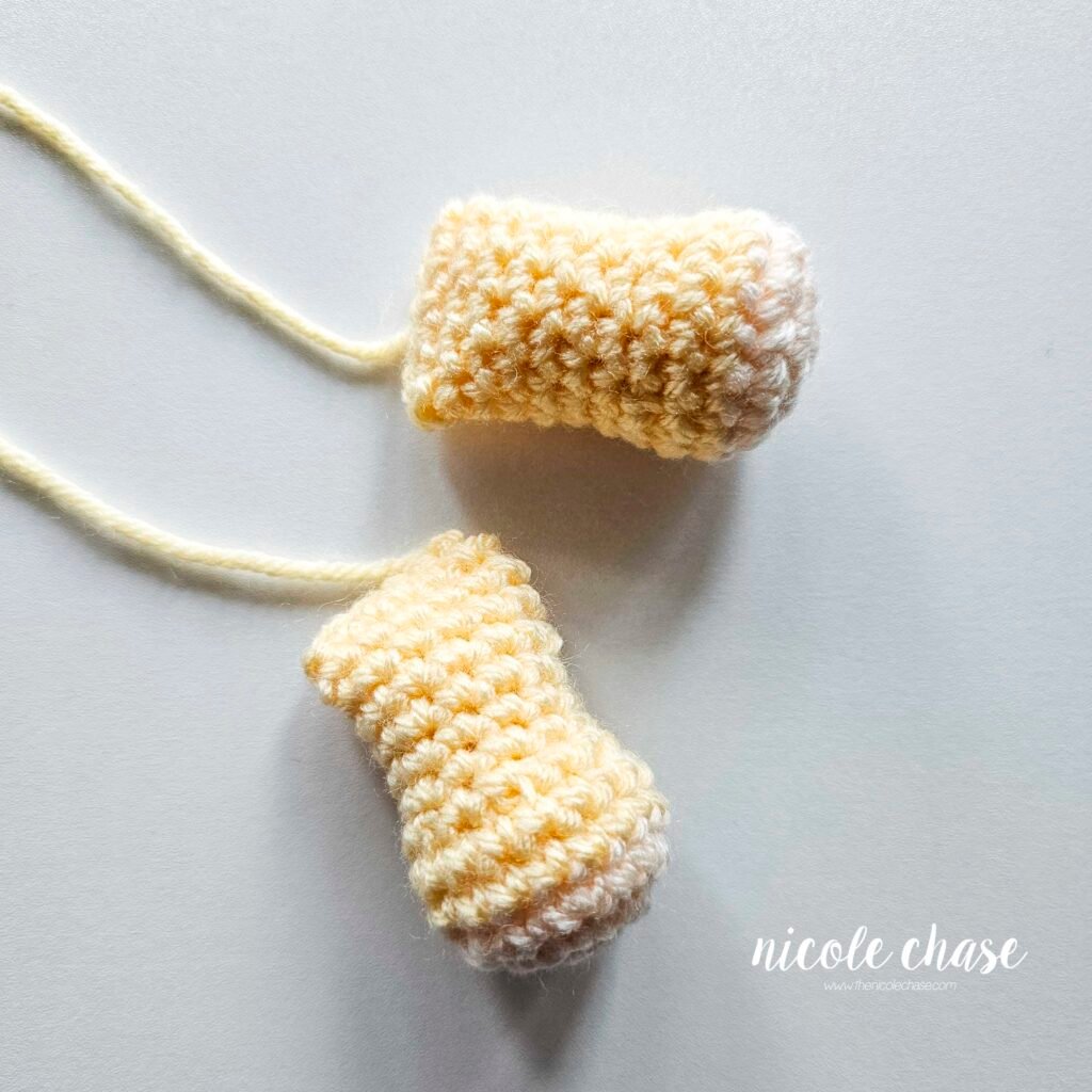 Finished crochet arms for the Hug Me Lion Lovey crochet pattern.