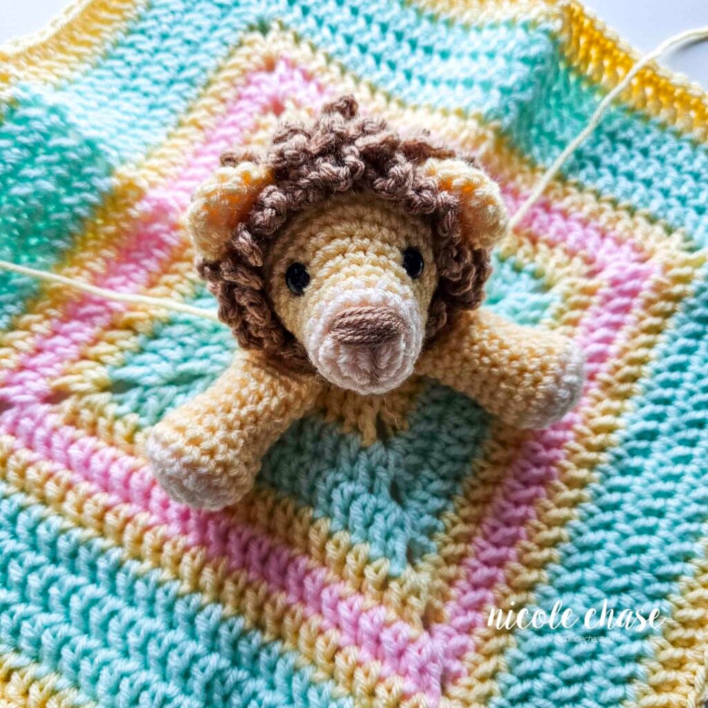 Arm placement for the crochet lion lovey prior to sewing.