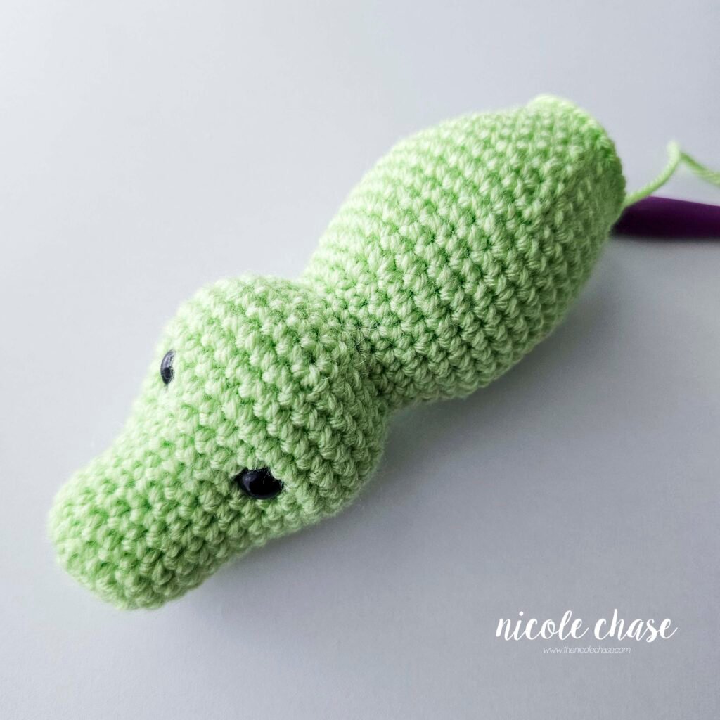 The crochet Alan the Alligator amigurumi after the body has been crocheted and filled with stuffing, prior to moving on to the tail.