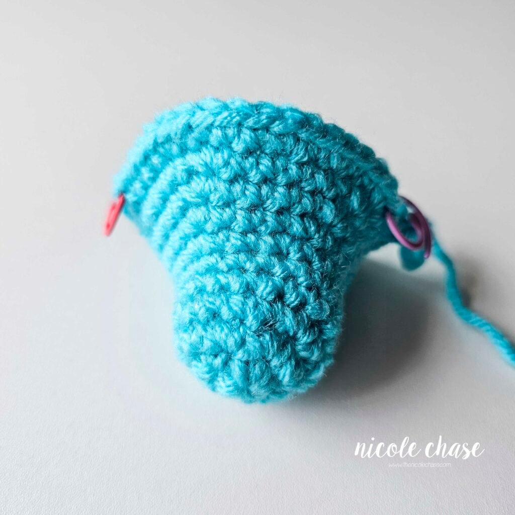 The head of Danny the Dragon in bright blue yarn after the completion of R11, prior to adding the safety eyes.