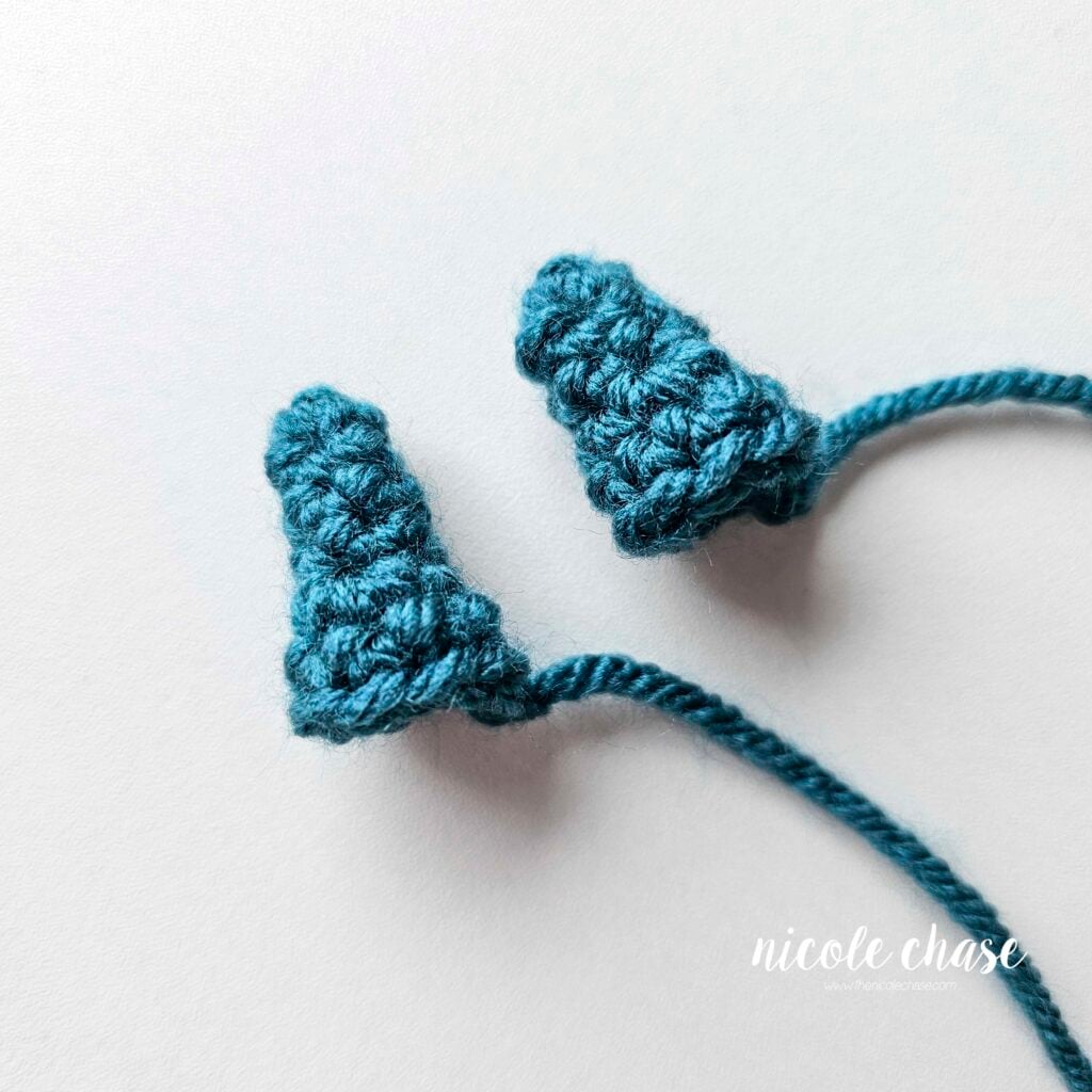 Two larger spikes made in teal yarn for the crochet dragon.
