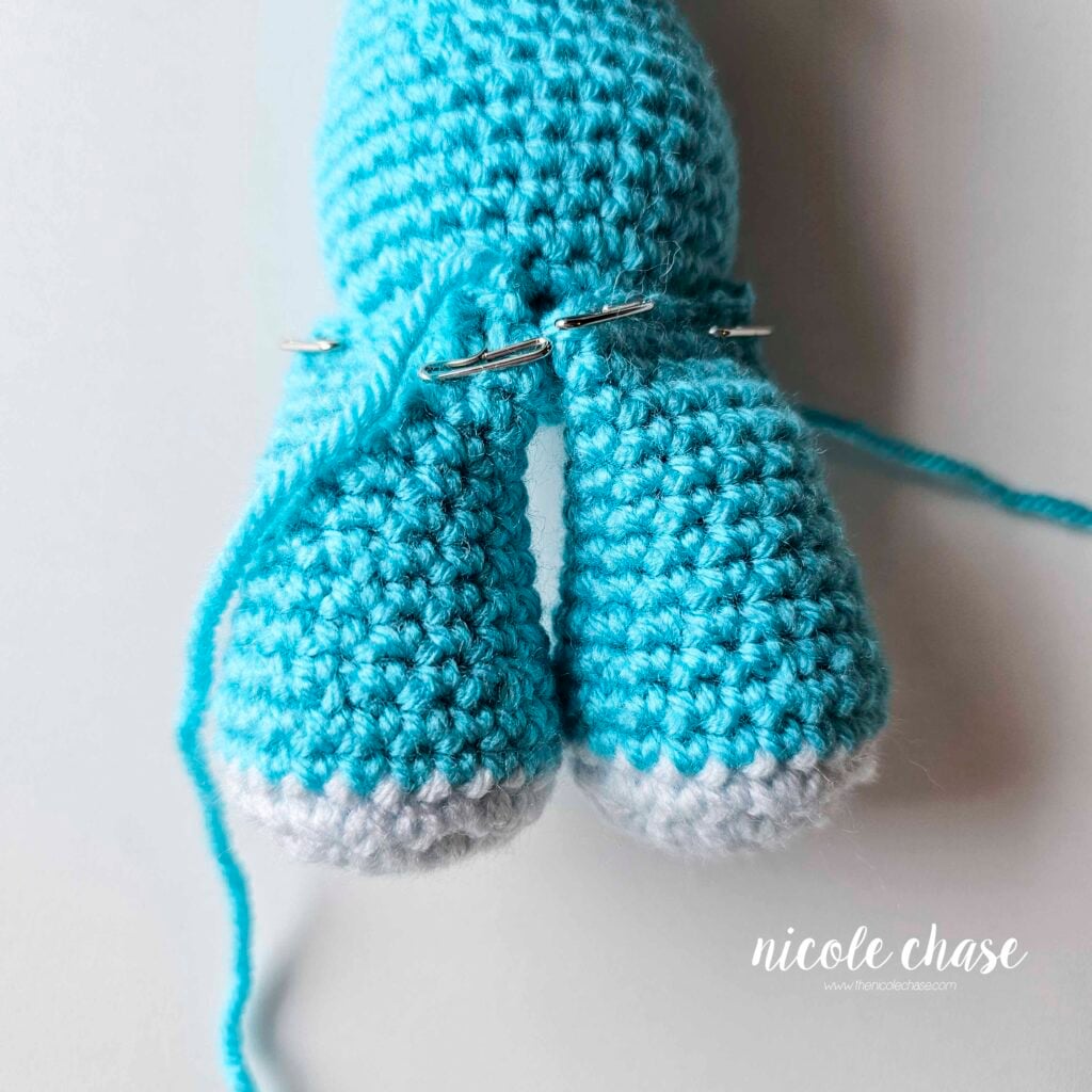 The legs of the dragon have been pinned into place on the bottom front of the body and are awaiting sewing.