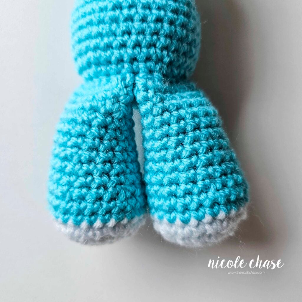 The dragon legs have been sewn into place on the front of the body.