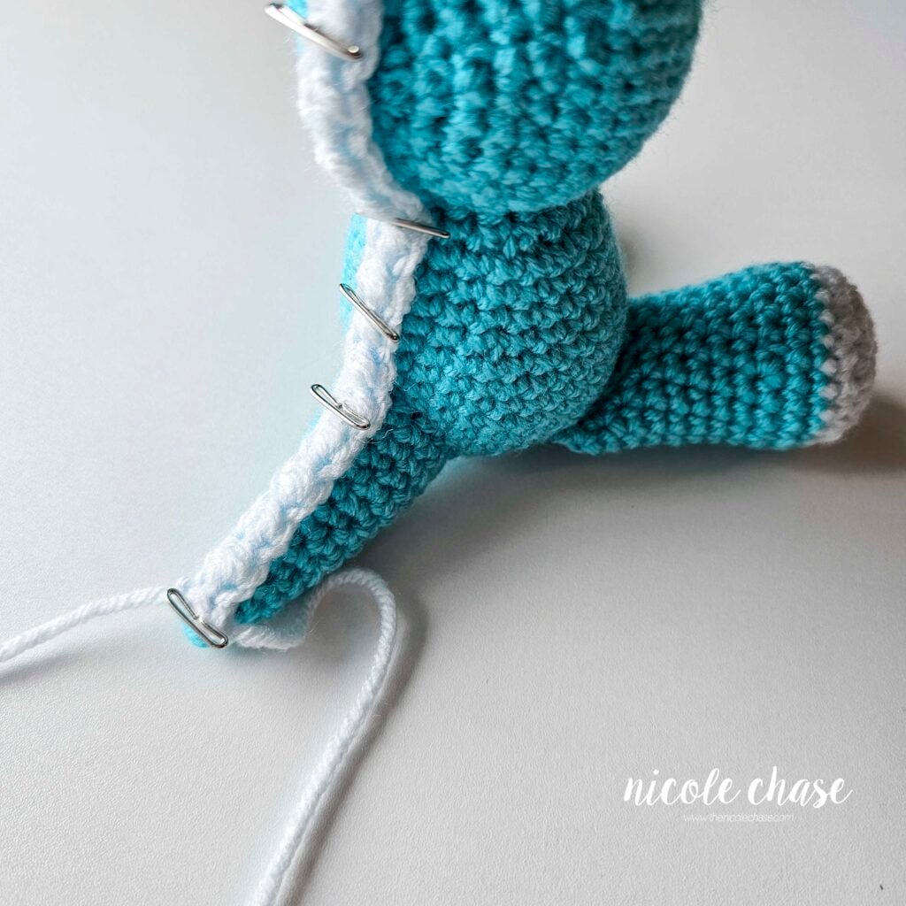 The long ridge piece has been pinned into place on the back of the dragon, starting at the tip of the tail and pinned up the body and head.