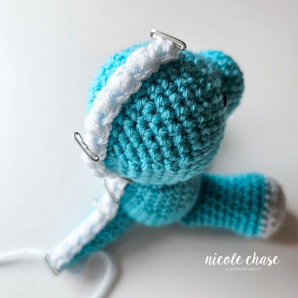 The long ridge piece is pinned into place and awaiting sewing from the tip of the tail, up the body, and on top of the head.