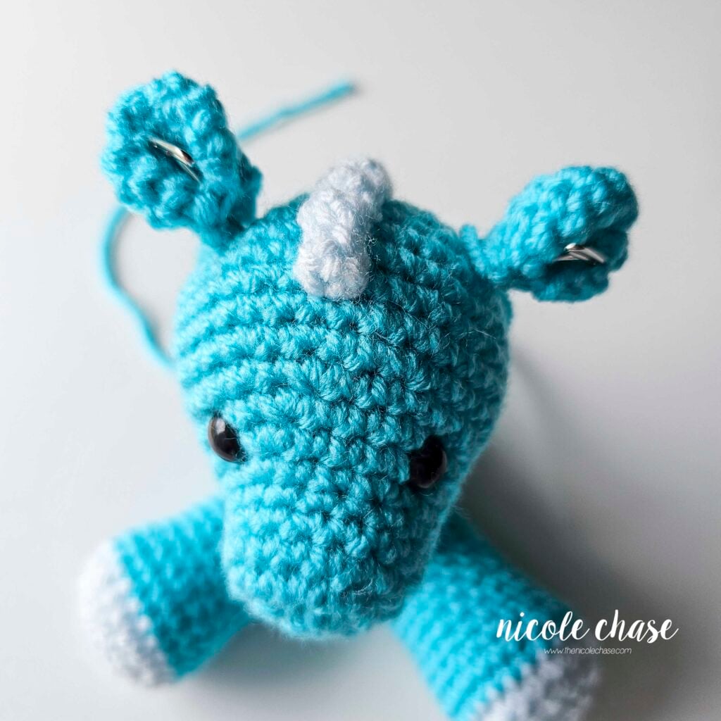 The ears of the dragon have been pinned into place on each side of the top of the head.