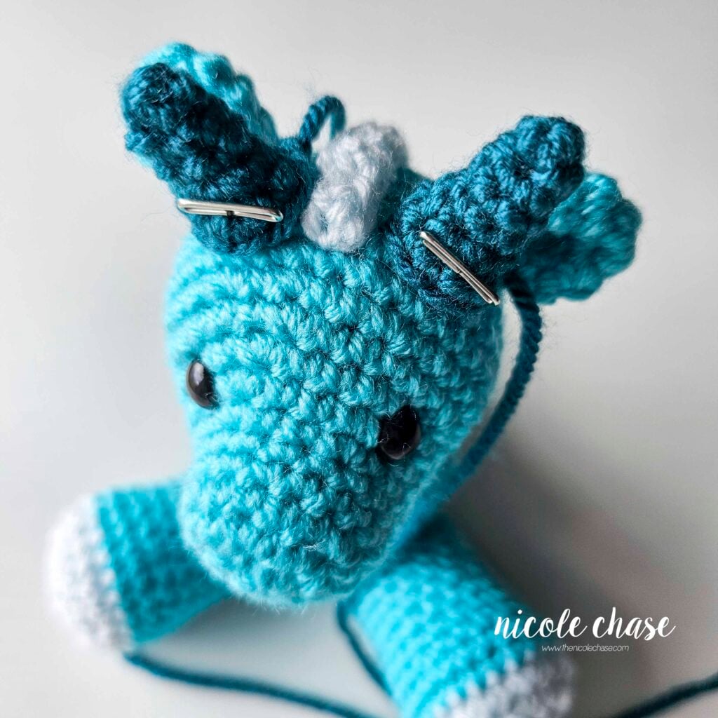 The large spikes have been pinned into place on each side of the ridge on the top of the dragon's head and are awaiting sewing.