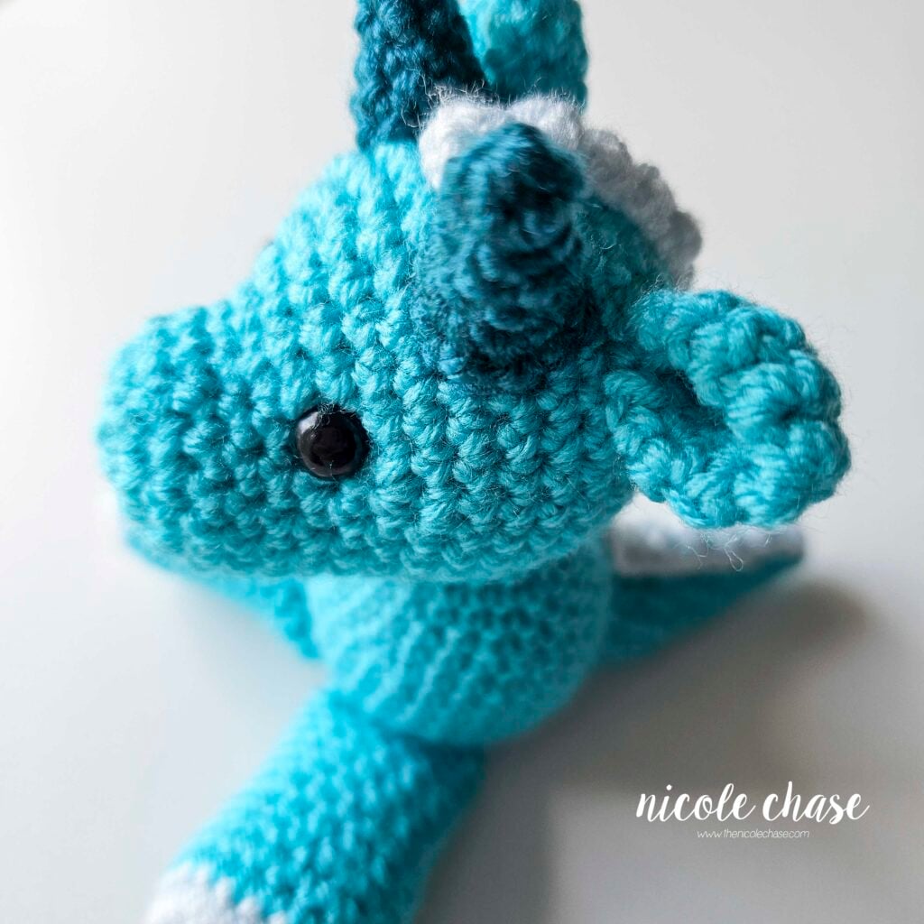 A side view of the large spikes having been sewn into place on the top of the head.