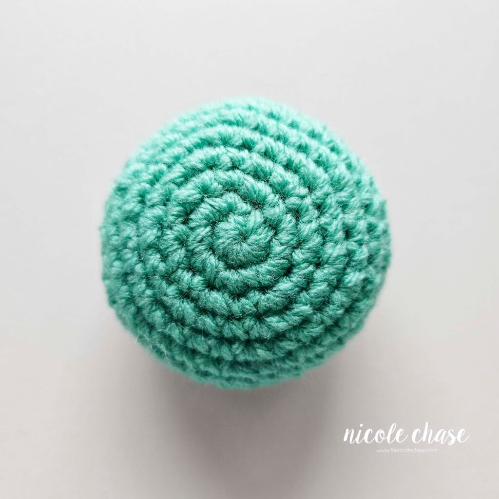 The teal crochet shell of the free snail crochet pattern.