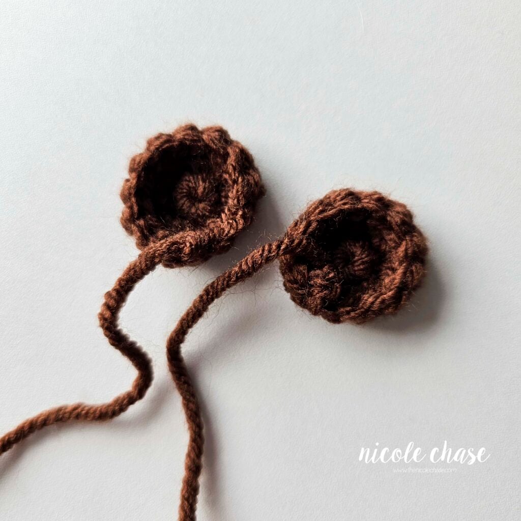Two brown crochet circles for the ears of the crochet monkey, finished and awaiting assembly. 