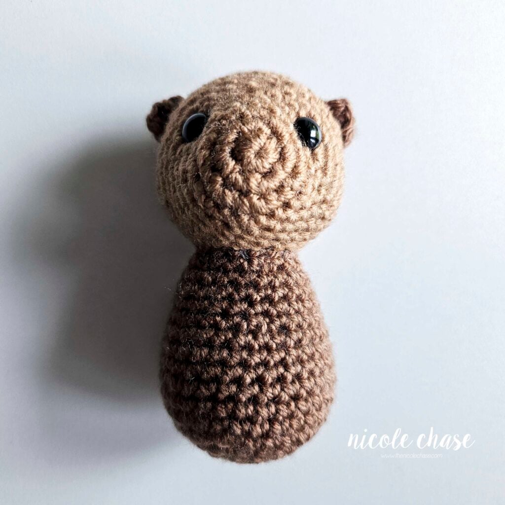 A front view of the head and body of the otter sewn into place.