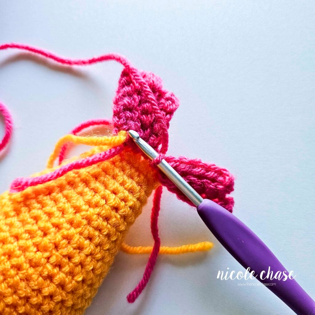 R3 has been joined with a slip stitch to the base of the crochet fish body.