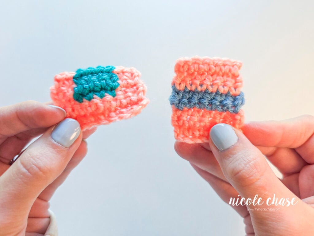 Hands holding two small crochet swatches showing different yarn color changes in pink, teal, and blue yarn, demonstrating different methods for how to change colors in crochet.