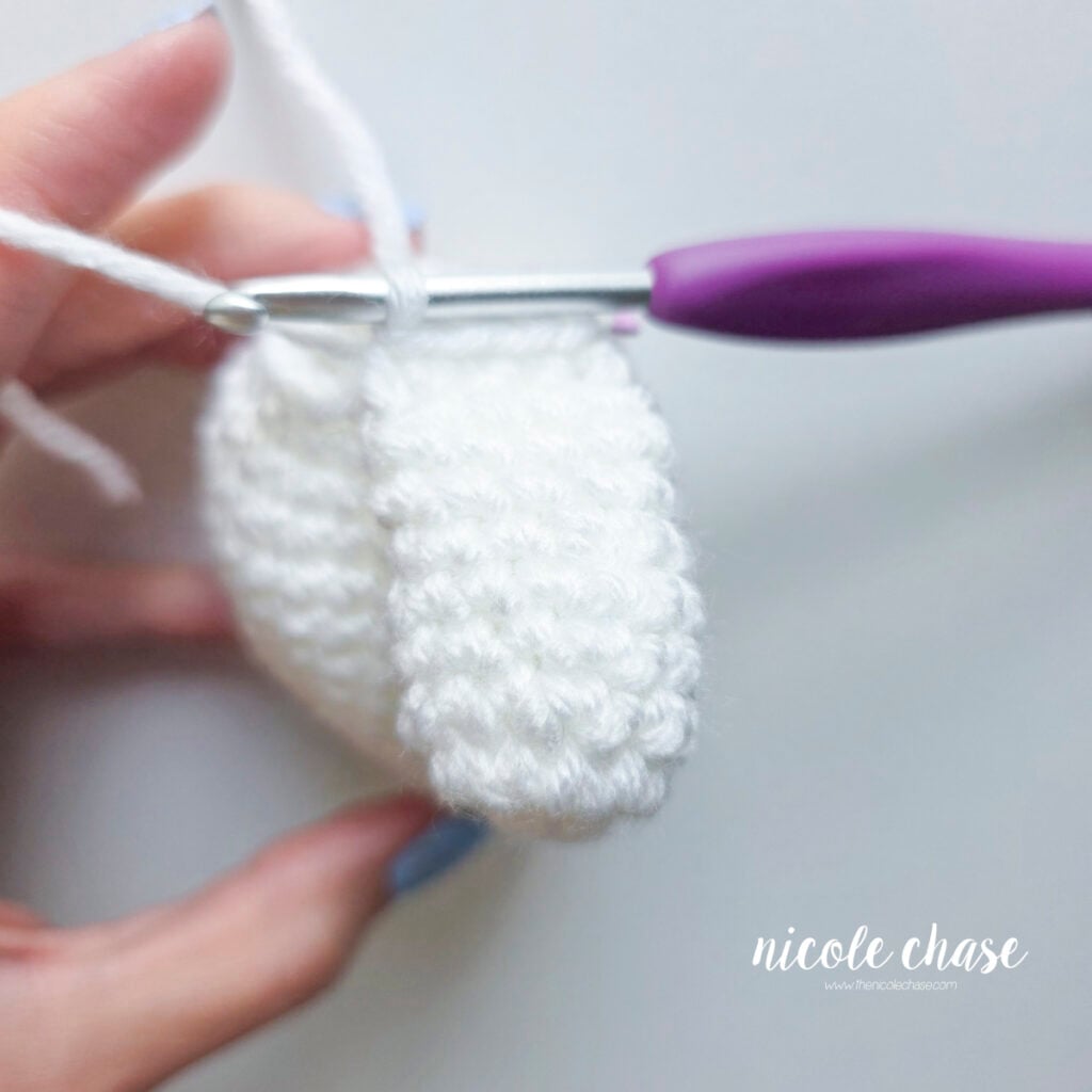 The first arm of the crochet ghost has been crocheted full to the body.
