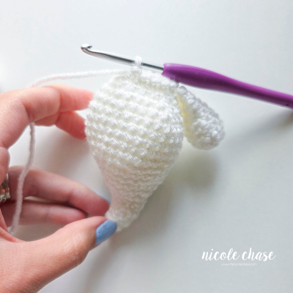 The single crochet stitches between the first arm and the second arm have been crocheted on the ghost's body.