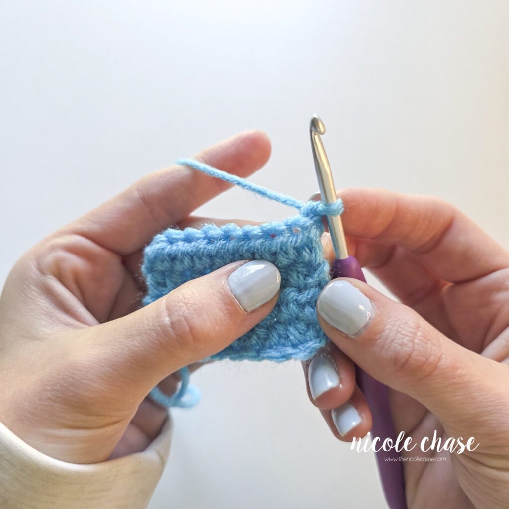 Starting with a chain 1, a crochet hook is ready to start the half double crochet stitch. 