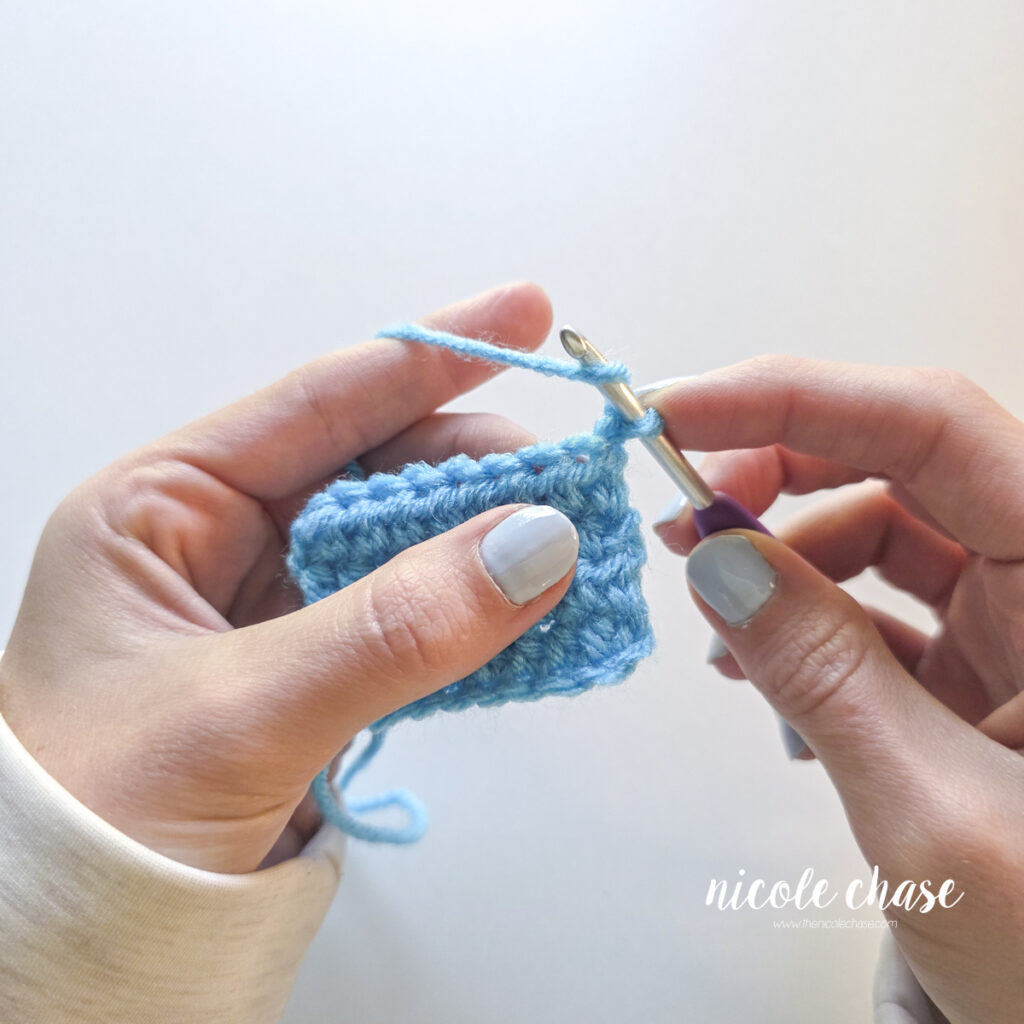 Yarning over the crochet hook before inserting into the stitch. 