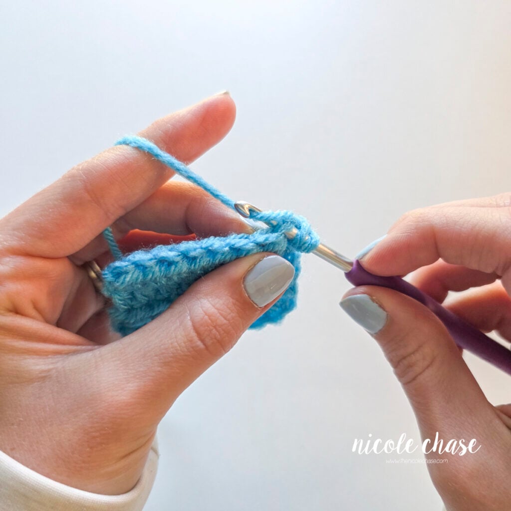 Yarning over behind the stitch to draw up a loop. 