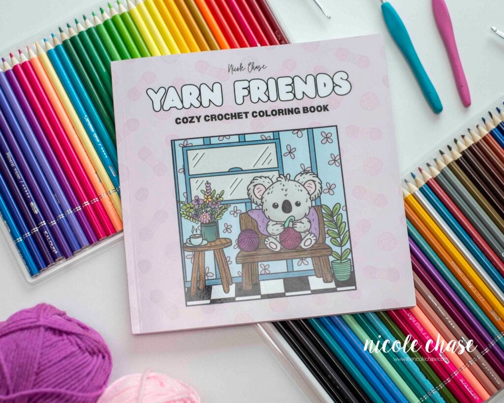 Yarn Friends Cozy Crochet Coloring Book cover by Nicole Chase, framed by colorful pencils, yarn, and crochet hooks.