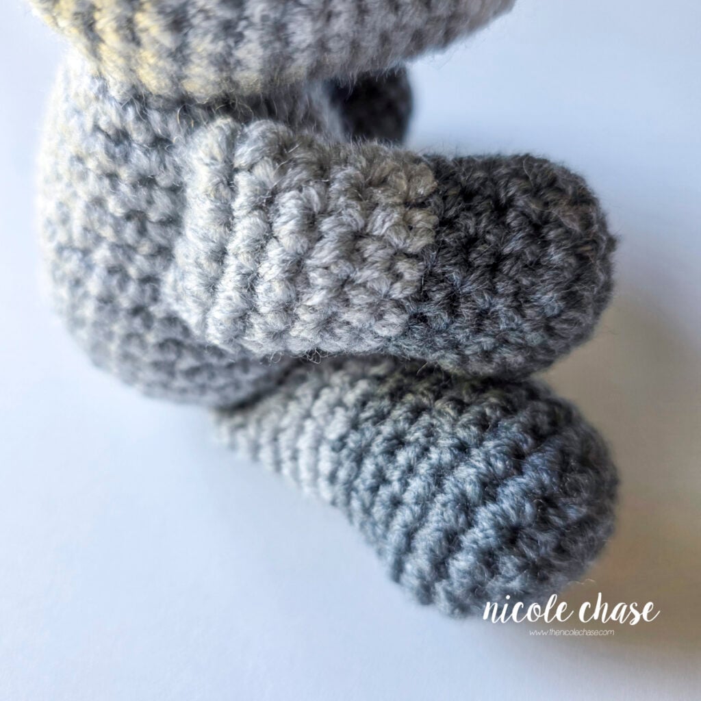 A side view of the crochet arms have been sewn into place on each side of the body. 